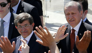 Turkey's Prime Minister Tayyip Erdogan (R) and Foreign Minister Ahmet Davutoglu greet their supporters as they leave Friday prayers in Ankara August 22, 2014. Erdogan, who will be sworn in as president next Thursday, named Davutoglu as his future prime minister on Thursday and vowed a power struggle against a U.S.-based cleric he accuses of plotting against him would continue. REUTERS/Umit Bektas (TURKEY - Tags: POLITICS) - RTR43CQ9